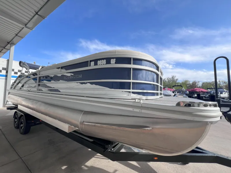 Slide: The Image of 2022 Bennington 25RSB pontoon boat on trailer under clear blue sky. - 3