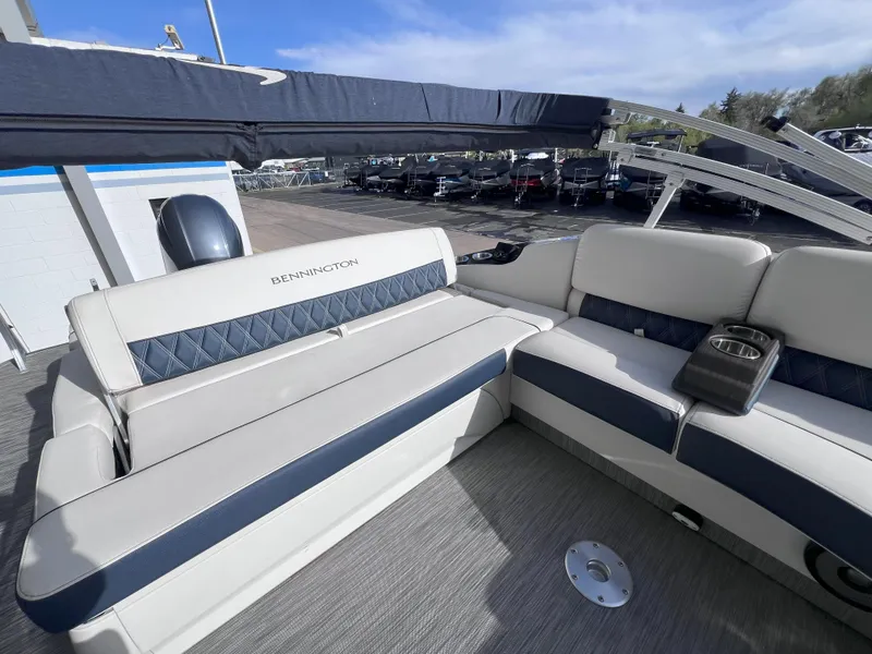 Slide: The Image of 2022 Bennington 25RSB boat interior with plush seating and cup holder. - 8