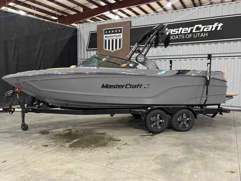 Slide: The Image of 2025 MasterCraft XT23 boat displayed indoors on a trailer. - 3