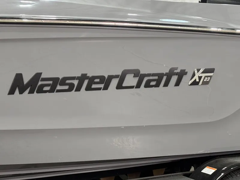 Slide: The Image of 2025 MasterCraft XT23 boat logo on a sleek gray hull. - 4