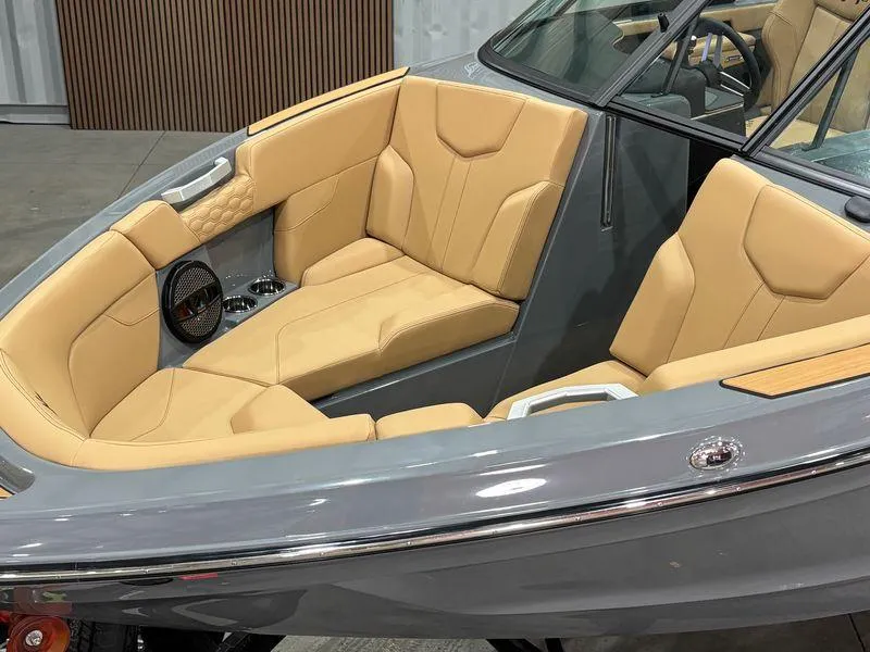 Slide: The Image of 2025 MasterCraft XT23 boat interior with tan seating and sleek design. - 5