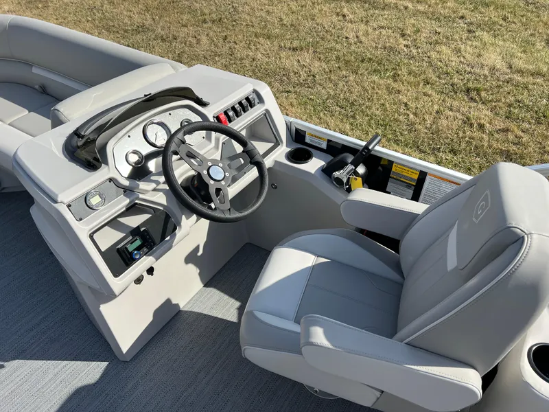 Slide: The Image of 2025 Godfrey Xperience Split Bench boat interior with steering wheel and seating. - 16