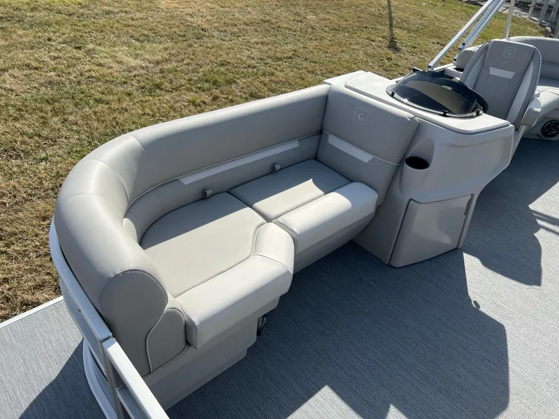 Slide: The Image of 2025 Godfrey Xperience Split Bench with gray upholstery on a boat deck. - 8