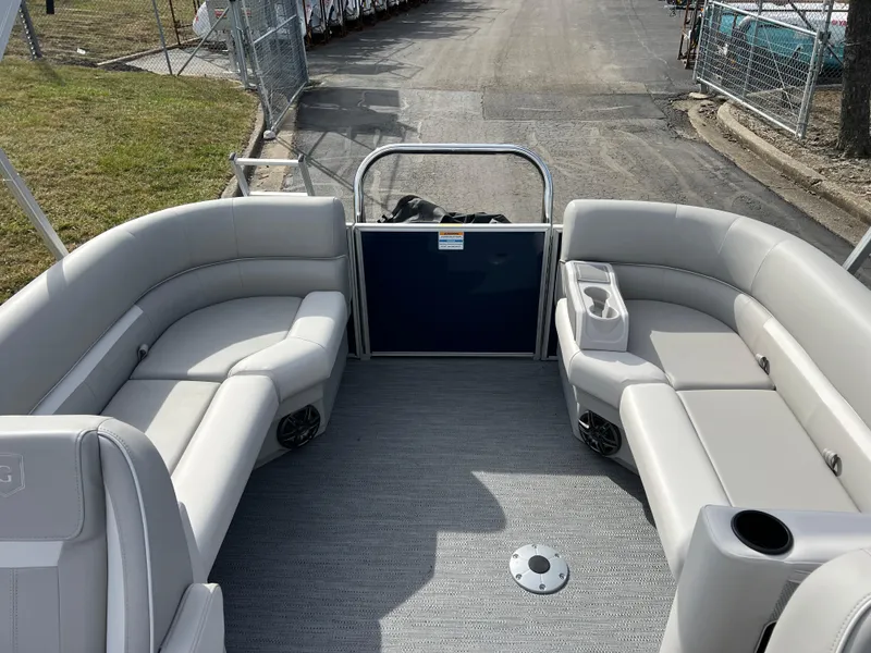 Slide: The Image of 2025 Godfrey Xperience Split Bench boat interior with gray seating and cup holders. - 10