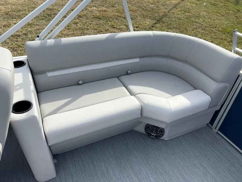 Slide: The Image of 2025 Godfrey Xperience Split Bench with light gray upholstery and cup holders on a boat. - 11