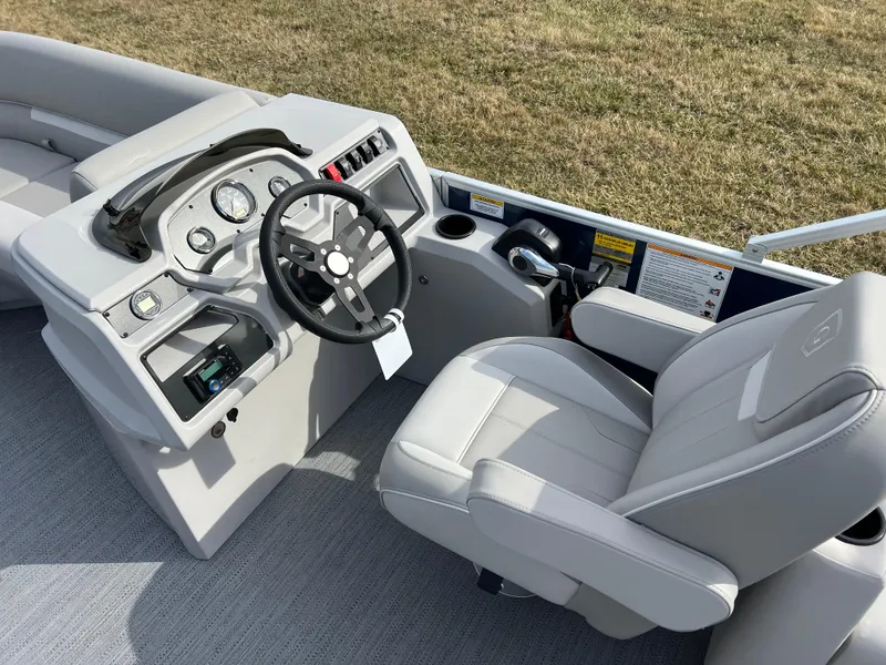 Slide: The Image of 2025 Godfrey Xperience Split Bench boat interior with steering wheel and controls. - 14