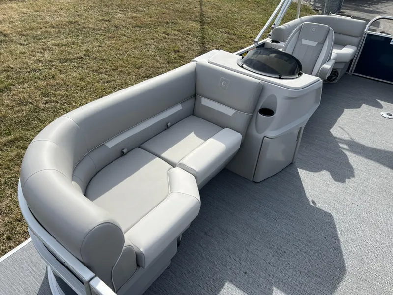 Slide: The Image of 2025 Godfrey Xperience Split Bench boat interior with gray seating and console. - 7
