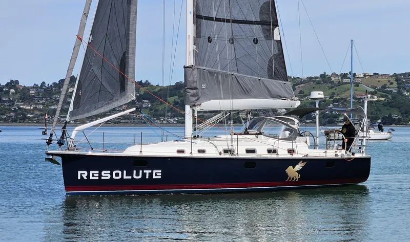 Slide: The Image of Sailboat "Resolute" on water, Blue Jacket 40 model, 2015, with scenic background. - 1
