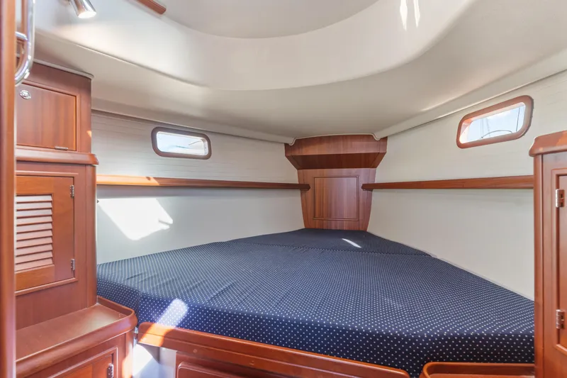 Slide: The Image of Cozy cabin interior of 2015 Blue Jacket 40 sailboat with wooden finish and porthole windows. - 24