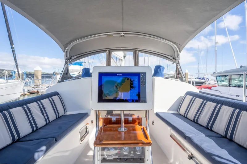 Slide: The Image of Interior of 2015 Blue Jacket 40 sailboat with striped seating and navigation screen. - 7