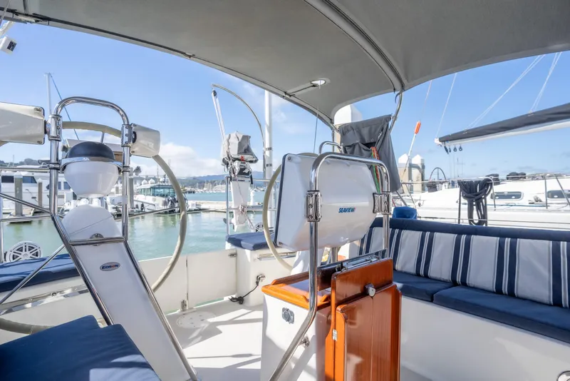 Slide: The Image of Spacious cockpit of 2015 Blue Jacket 40 sailboat with striped seating and marina view. - 8