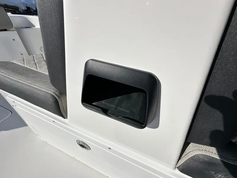 Slide: The Image of 2025 Sea Pro 240 Dual Console interior detail with storage compartment and seating. - 13
