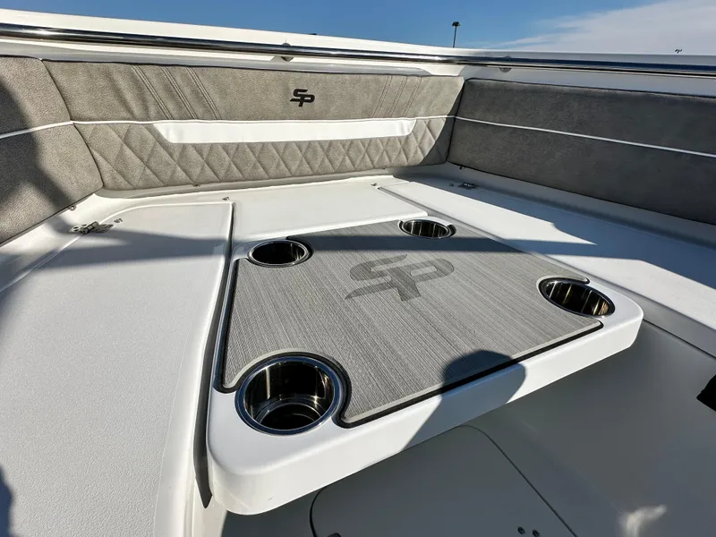 Slide: The Image of 2025 Sea Pro 240 Dual Console boat interior with table and cup holders. - 16