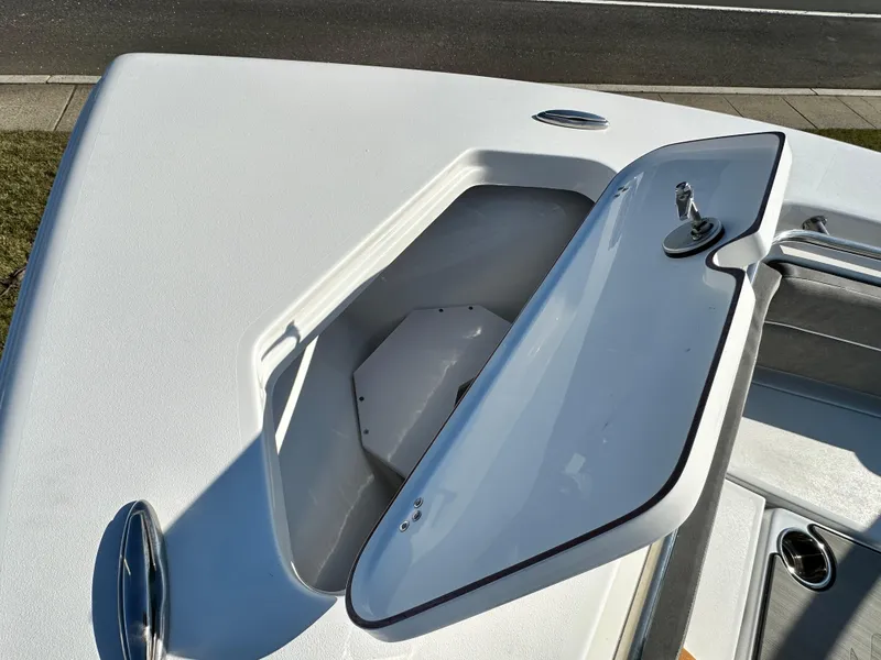 Slide: The Image of 2025 Sea Pro 240 Dual Console boat storage compartment with open hatch. - 23