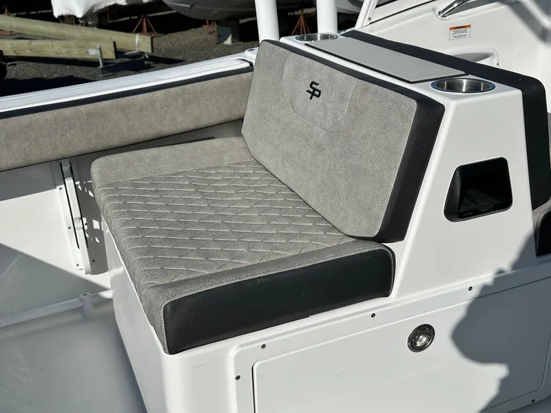 Slide: The Image of 2025 Sea Pro 240 Dual Console boat seating with cup holders and gray upholstery. - 25