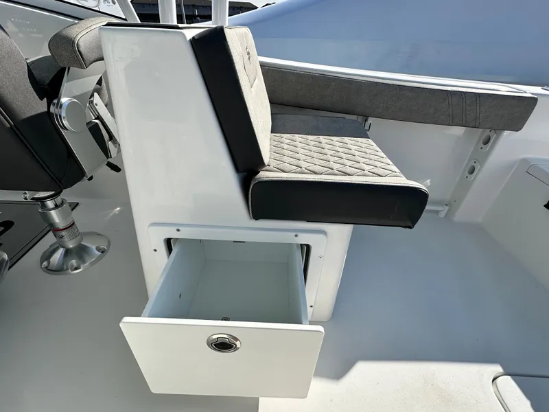 Slide: The Image of 2025 Sea Pro 240 Dual Console boat seat with storage drawer open. - 26