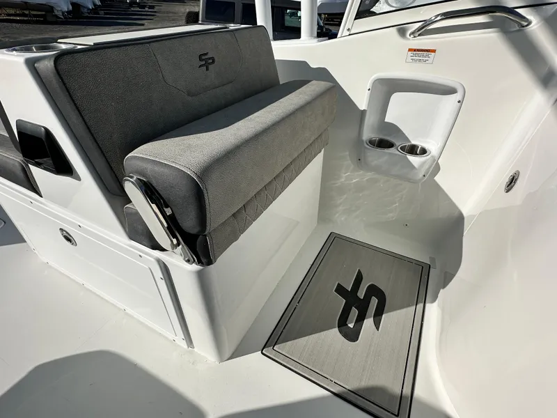 Slide: The Image of 2025 Sea Pro 240 Dual Console interior with gray seating and branded floor mat. - 27
