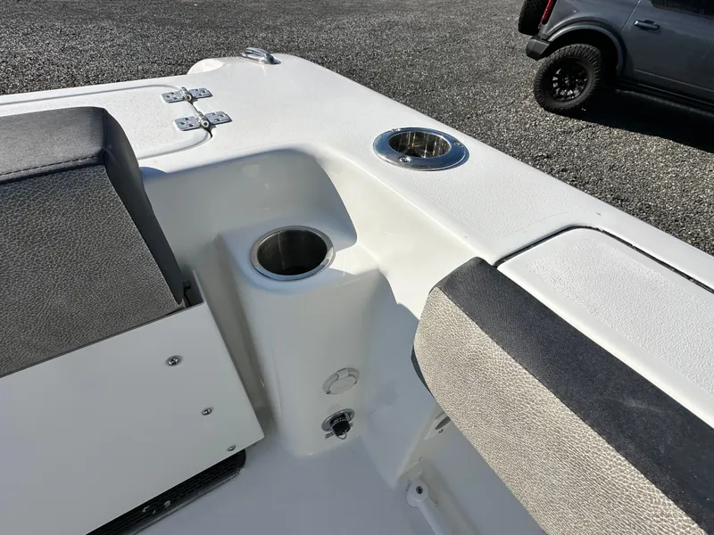 Slide: The Image of 2025 Sea Pro 240 Dual Console boat interior with cup holders and seating. - 28