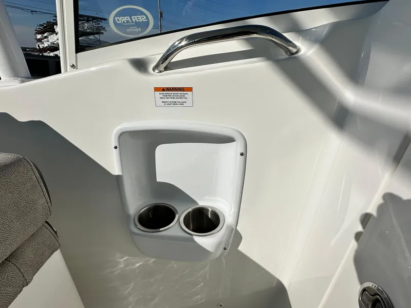 Slide: The Image of 2025 Sea Pro 240 Dual Console interior with cup holders and grab handle. - 29