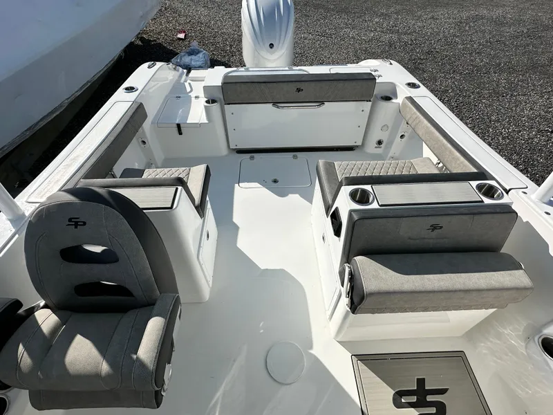 Slide: The Image of 2025 Sea Pro 240 Dual Console boat interior with gray seating and cup holders. - 3