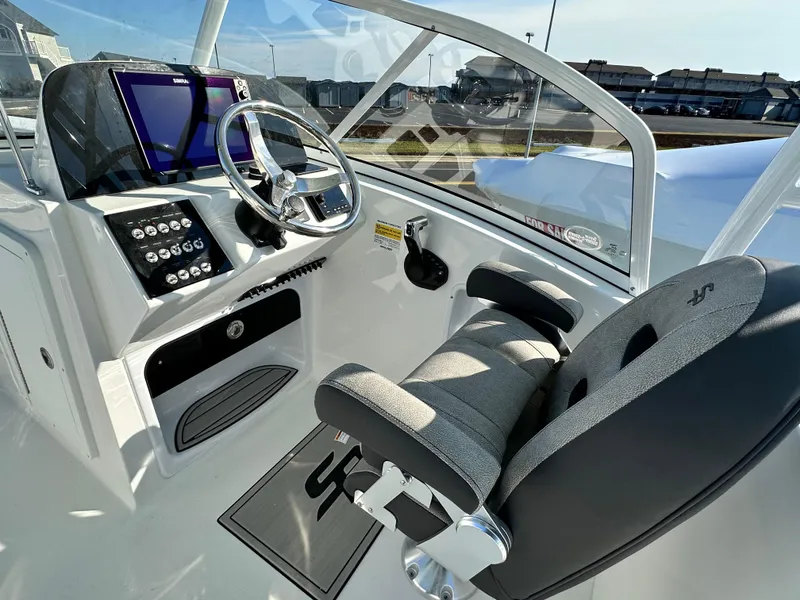 Slide: The Image of 2025 Sea Pro 240 Dual Console boat interior with steering wheel and control panel. - 5