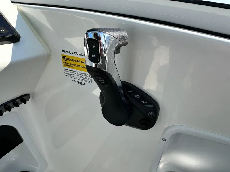 Slide: The Image of Throttle control on 2025 Sea Pro 240 Dual Console boat dashboard. - 6