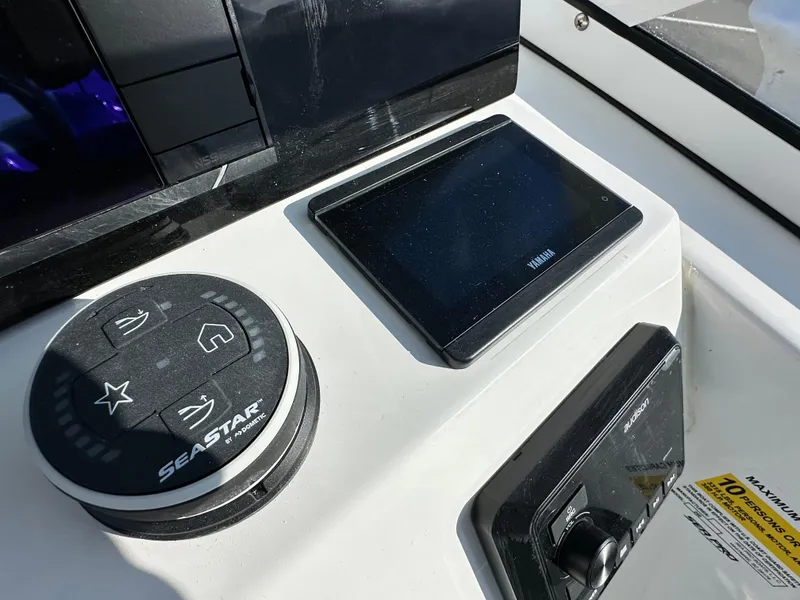 Slide: The Image of Control panel of 2025 Sea Pro 240 Dual Console boat with SeaStar and Yamaha displays. - 7