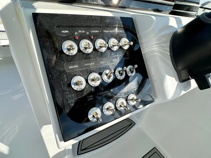 Slide: The Image of Control panel of 2025 Sea Pro 240 Dual Console boat with multiple switches. - 8