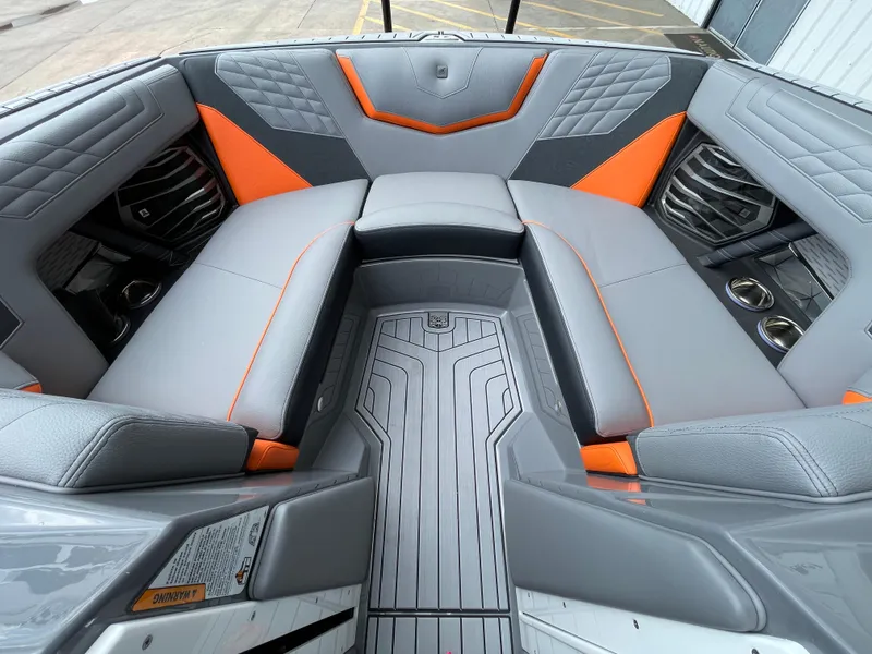 Slide: The Image of 2023 Nautique Super Air Nautique G21 interior with gray and orange seating. - 12