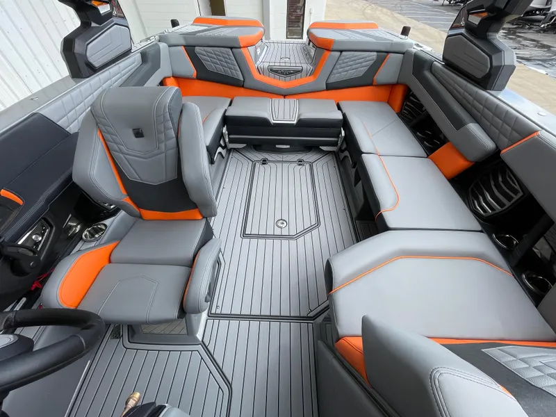 Slide: The Image of 2023 Nautique Super Air Nautique G21 interior with gray and orange seating. - 14