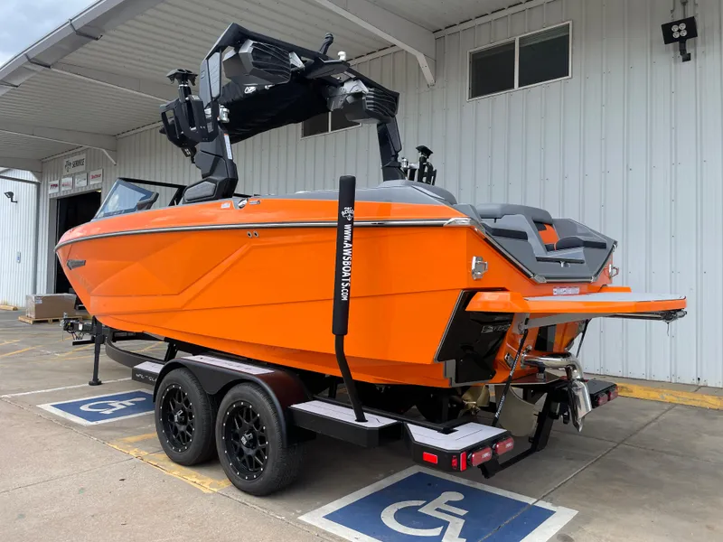 Slide: The Image of 2023 Nautique Super Air Nautique G21 boat in vibrant orange on a trailer. - 3