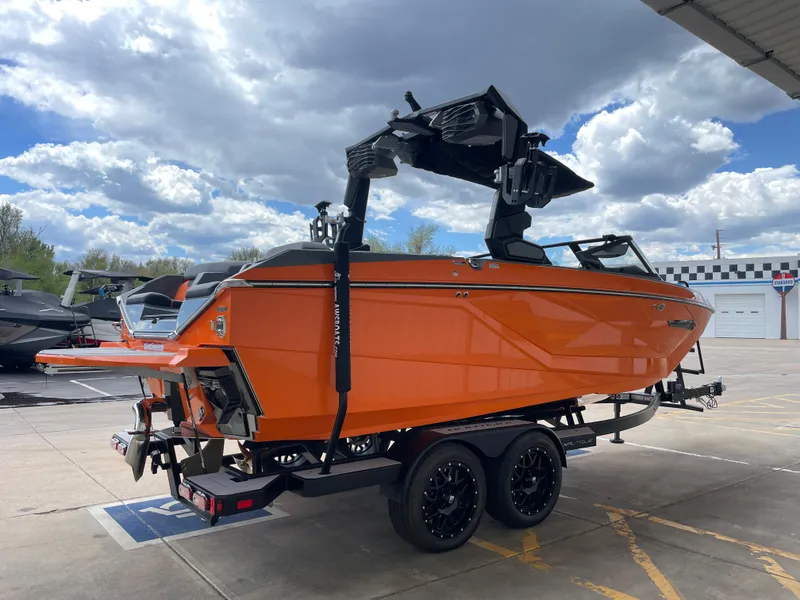 Slide: The Image of 2023 Nautique Super Air Nautique G21 boat in vibrant orange on a trailer. - 5
