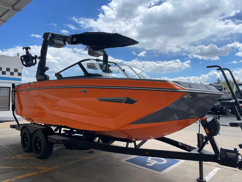 Slide: The Image of 2023 Nautique Super Air Nautique G21 boat in vibrant orange on a trailer. - 7