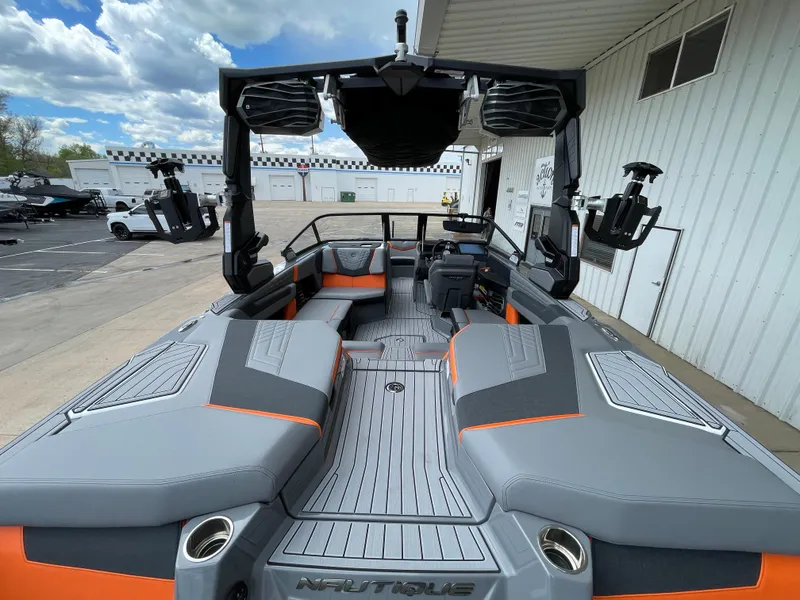 Slide: The Image of 2023 Nautique Super Air Nautique G21 boat interior with gray and orange seating. - 8