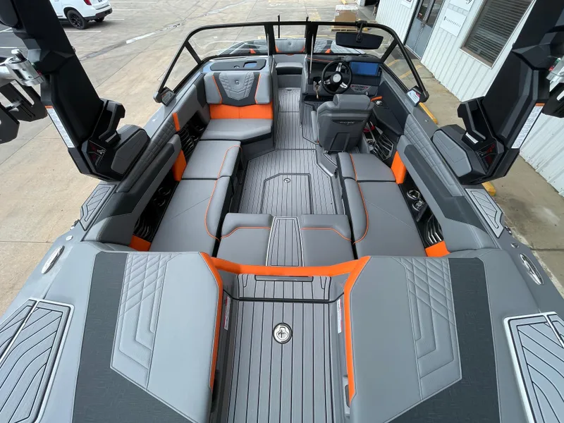 Slide: The Image of 2023 Nautique Super Air Nautique G21 interior with gray and orange seating. - 9
