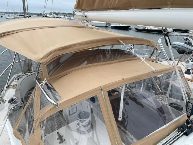 Slide: The Image of 1986 Mason 33 sailboat with beige canopy in harbor. - 12