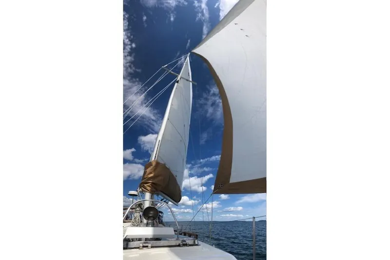 Slide: The Image of Sailing on a 1986 Mason 33 yacht under clear blue skies. - 16