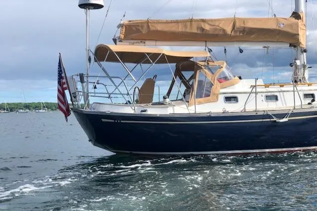 Slide: The Image of 1986 Mason 33 sailboat cruising on calm waters. - 3