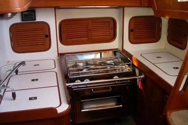 Slide: The Image of 1986 Mason 33 yacht kitchen with stove and wooden cabinetry. - 6