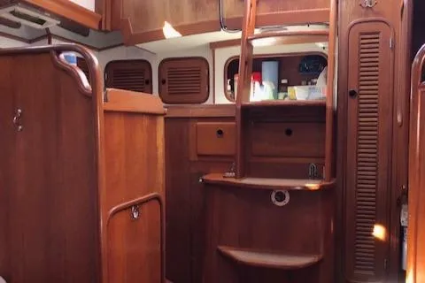 Slide: The Image of Interior of a 1986 Mason 33 yacht with wooden furnishings. - 8