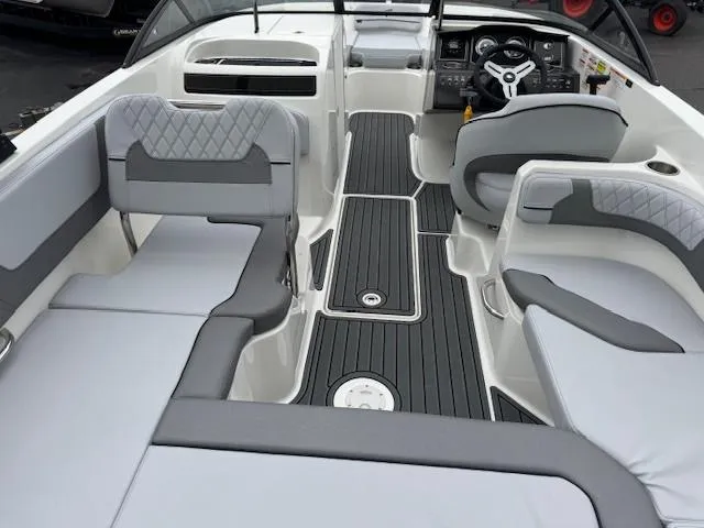 Slide: The Image of 2025 Bayliner VR6 Bowrider I/O interior with gray seating and modern dashboard. - 11