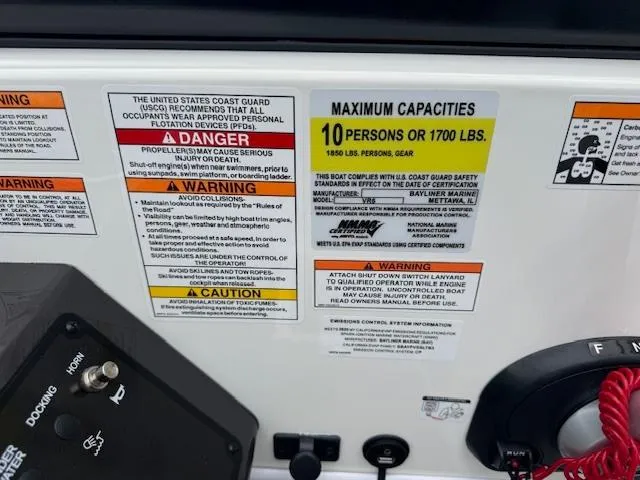 Slide: The Image of 2025 Bayliner VR6 Bowrider I/O capacity label, max 10 persons or 1700 lbs, safety warnings. - 12
