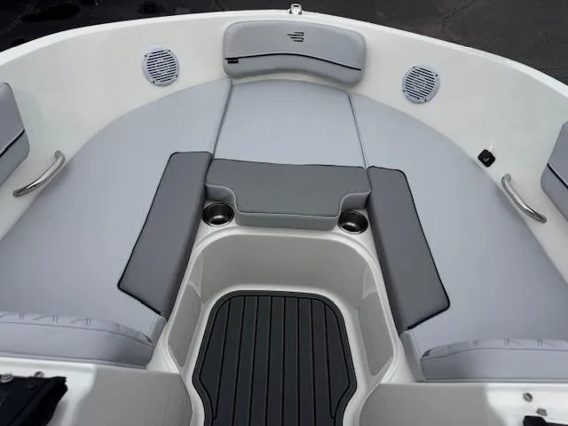 Slide: The Image of 2025 Bayliner VR6 Bowrider I/O interior with gray seating and cup holders. - 7