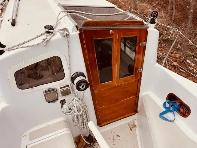 Slide: The Image of Cockpit view of 2006 Robert Perry Far Harbour 39 sailboat with wooden cabin door. - 12