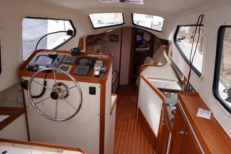 Slide: The Image of Interior of 2006 Robert Perry Far Harbour 39 yacht, featuring helm and wooden cabinetry. - 13