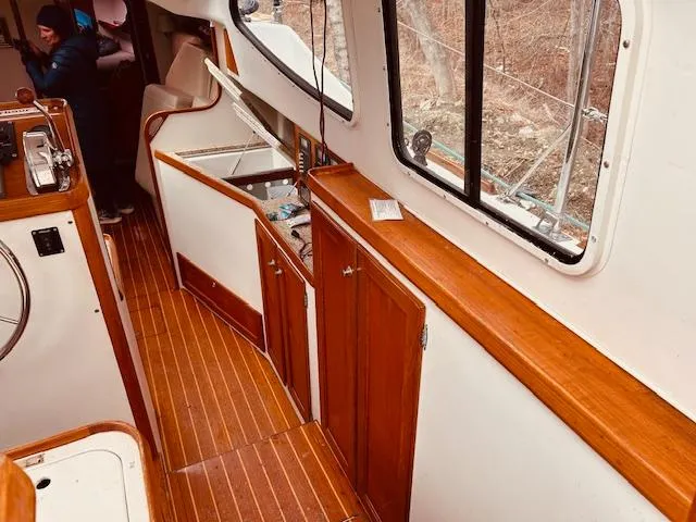 Slide: The Image of Interior of 2006 Robert Perry Far Harbour 39 yacht with wood finishes and seating area. - 15