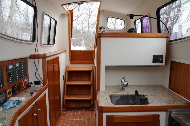 Slide: The Image of Interior of 2006 Robert Perry Far Harbour 39 yacht with wooden cabinetry and compact kitchen. - 20