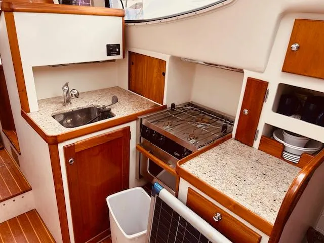 Slide: The Image of Compact kitchen in 2006 Robert Perry Far Harbour 39 yacht with sink, stove, and storage. - 21