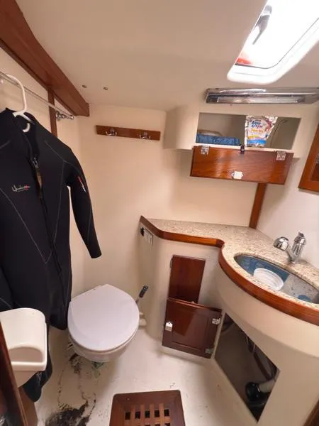 Slide: The Image of 2006 Robert Perry Far Harbour 39 yacht bathroom with wetsuit, sink, and storage. - 28