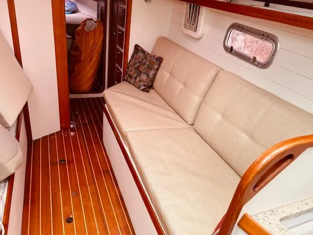 Slide: The Image of Interior of 2006 Robert Perry Far Harbour 39 yacht with beige seating and wooden flooring. - 32